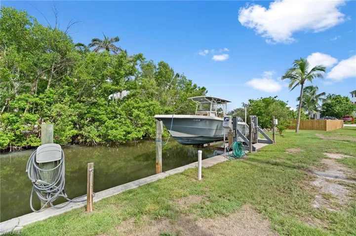 Deeded property with dock featuring boat lift.