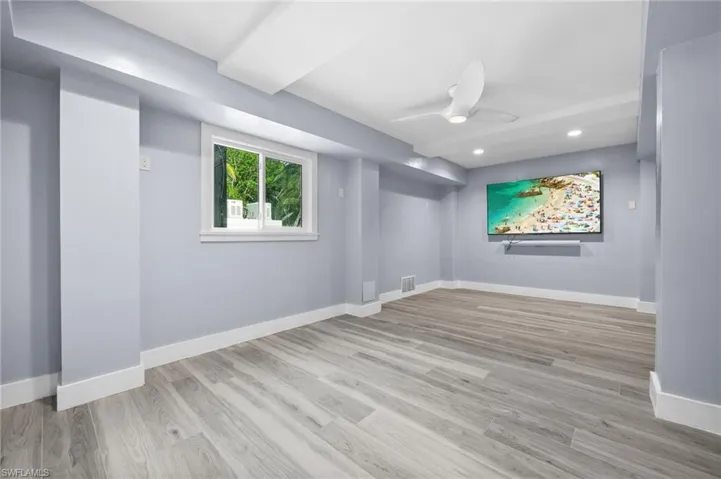 Media room on ground level with recessed lighting