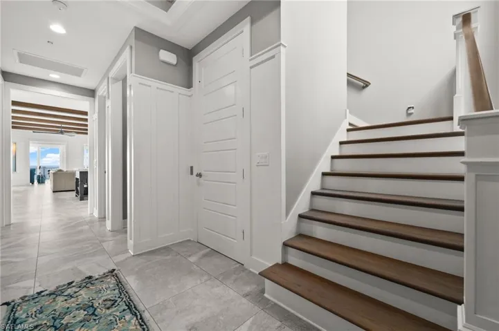 Second floor foyer featuring stairway, recessed lighting, and light marble finish tile flooring and elevator