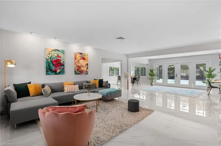 Living area with visible vents, marble finish floor, and french doors