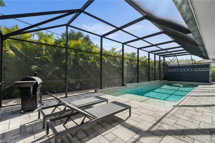 Pool with a patio area, grilling area, and a lanai