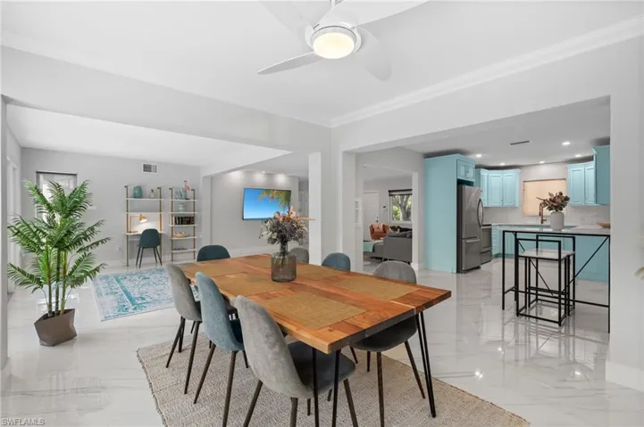 Dining room with visible vents, marble finish floor, crown molding, and ceiling fan