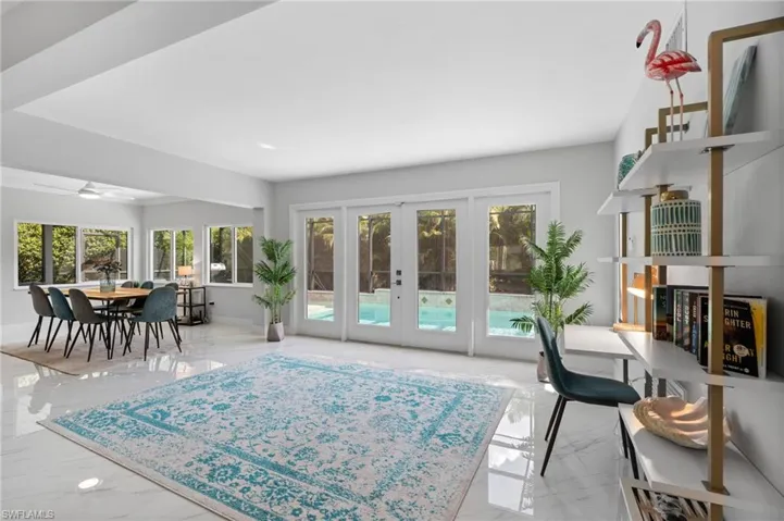 Living area with french doors and a ceiling fan