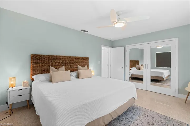 Bedroom with ceiling fan, a closet, visible vents, french doors, and baseboards