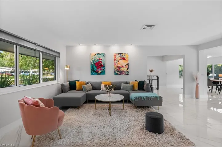 Living area with marble finish floor and visible vents