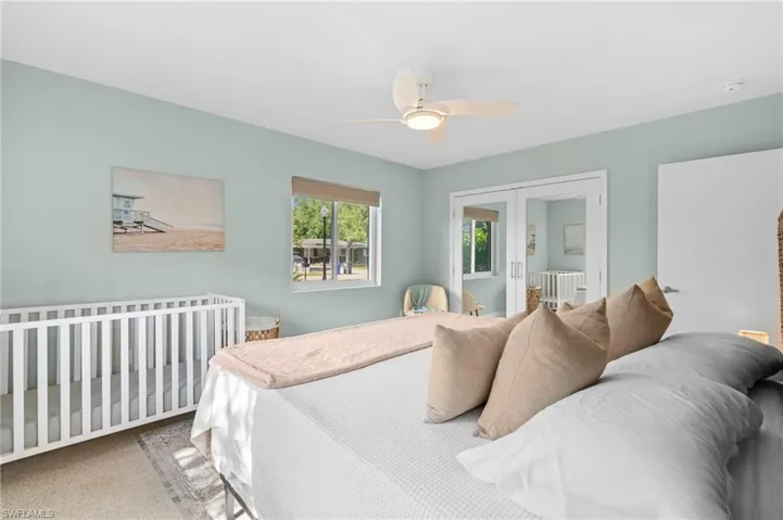 Bedroom featuring french doors, a ceiling fan, and carpet floors