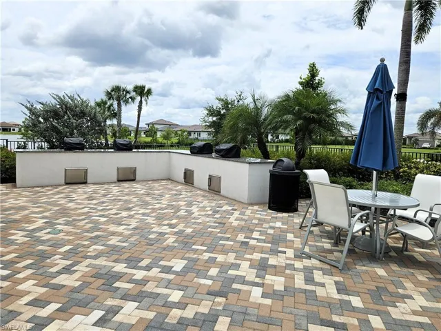 View of patio / terrace with fence, outdoor dining space, and area for grilling