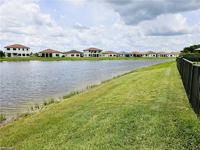 Property view of water with fence and a residential view