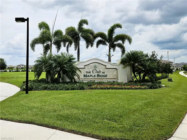 Community / neighborhood sign with a lawn