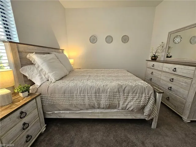 Bedroom featuring dark colored carpet