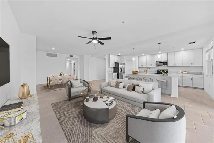 Open-concept living area featuring a modern ceiling fan, recessed lighting, and tile flooring
