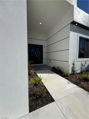 View of exterior entry featuring stucco siding