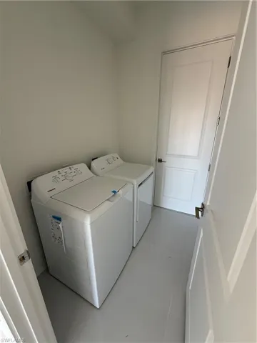Laundry area with washer and clothes dryer