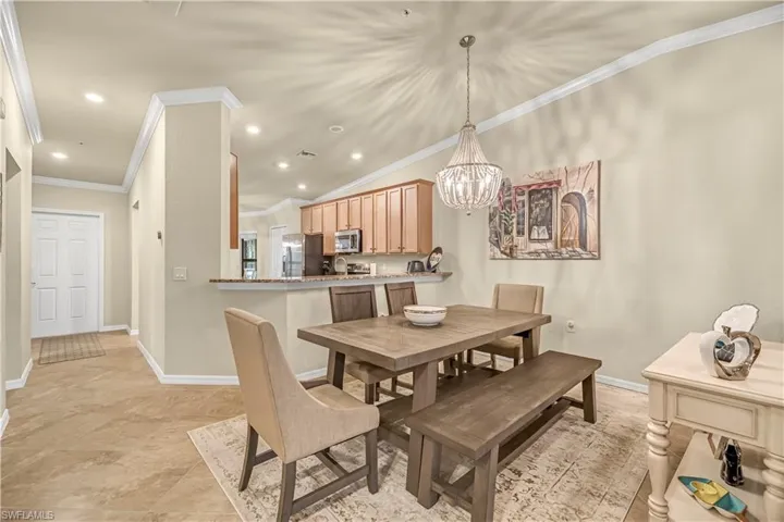 Dining space with recessed lighting, crown molding, and a chandelier