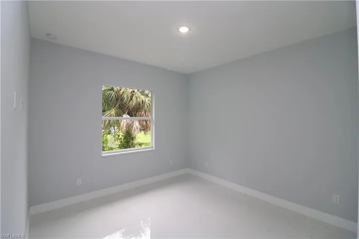 Unfurnished room featuring concrete flooring