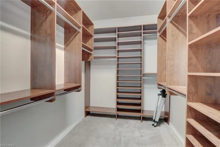 Master Closet with Built In Shelving & Rods