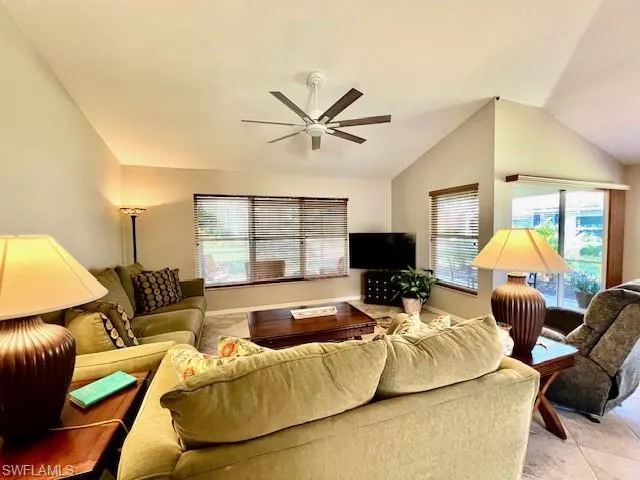 Living area featuring a ceiling fan and lofted ceiling