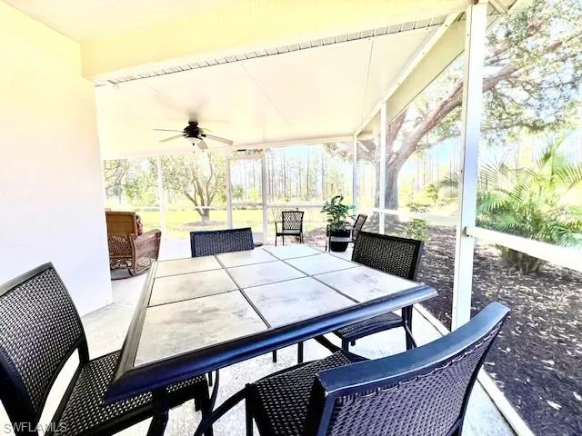Sunroom / solarium featuring ceiling fan and outdoor dining area