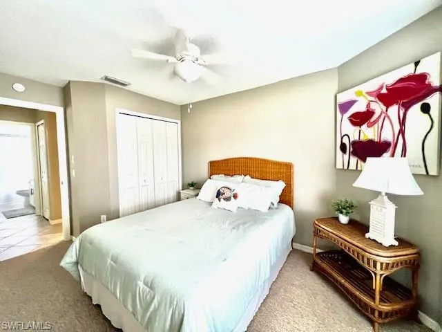 Bedroom featuring carpet, a closet, and a ceiling fan