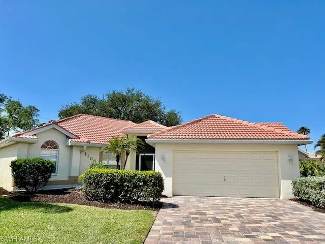 Mediterranean / spanish-style house with decorative driveway, a garage, a tile roof, and stucco siding