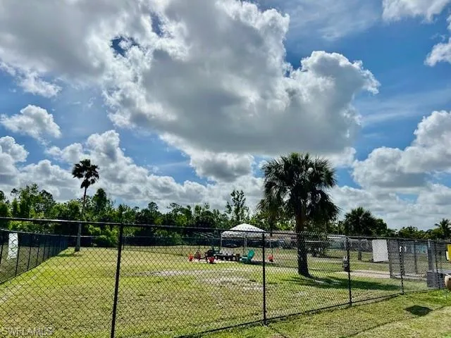 Surrounding community with a lawn and fence