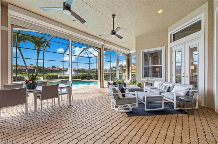View of patio / terrace with outdoor lounge area, a sunroom, french doors, a lanai, and a pool with connected hot tub
