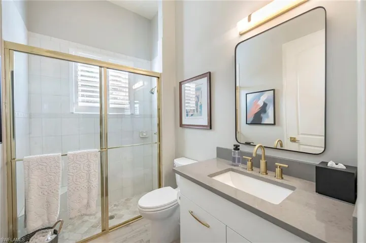 Full bathroom featuring vanity and a shower stall