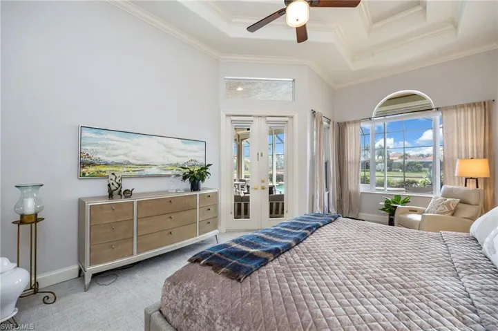 Bedroom featuring french doors, access to exterior, ceiling fan, a raised ceiling, and carpet flooring