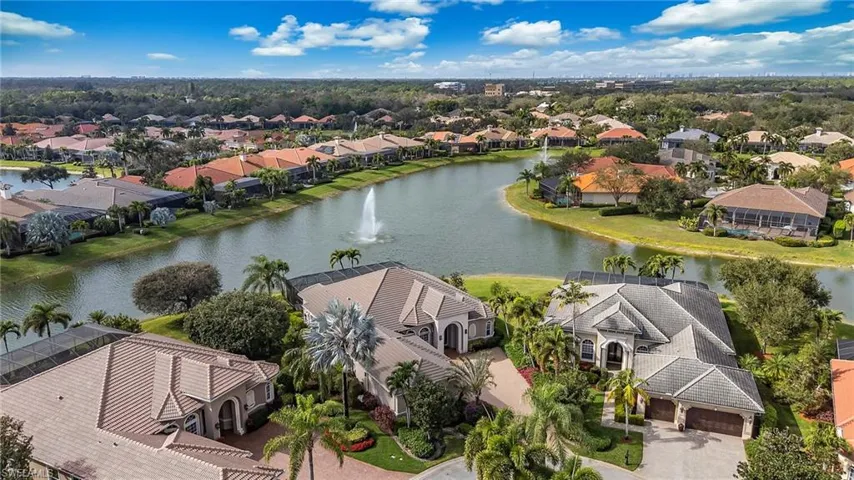 Aerial view of residential area featuring a nearby body of water