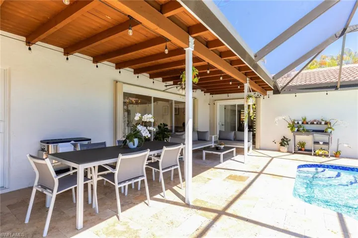 View of patio / terrace with outdoor dining space and a lanai