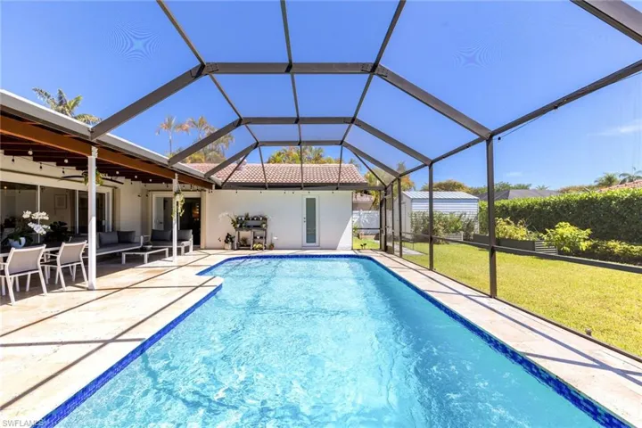 Outdoor pool with a patio, a yard, a lanai, and ceiling fan
