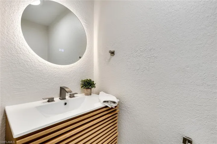 Bathroom with a sink and a textured wall