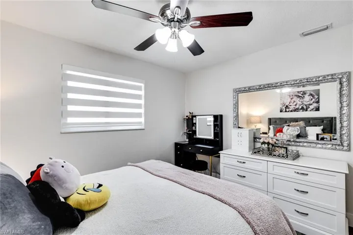 Bedroom with visible vents and ceiling fan
