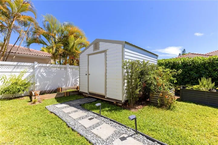 View of shed featuring fence