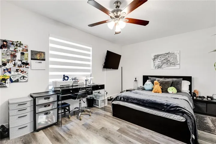 Bedroom with light wood finished floors and ceiling fan