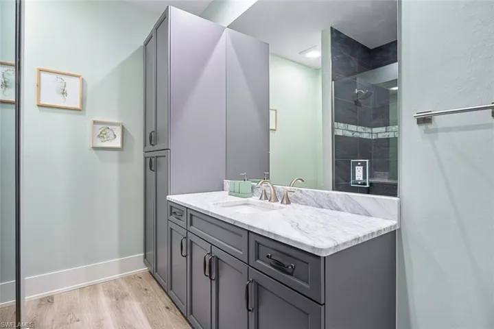 Bathroom with light wood-style flooring and vanity