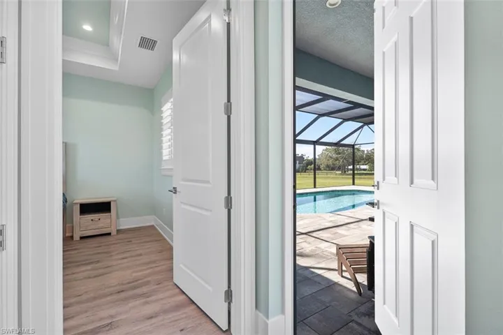 Hall with a sunroom and wood finished floors