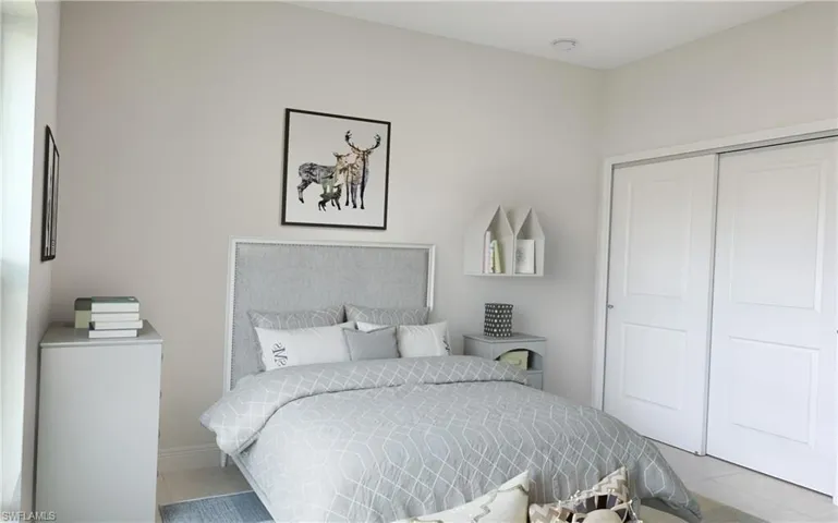 Tiled bedroom featuring a closet