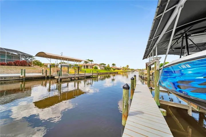 Dock area with a water view and boat lift