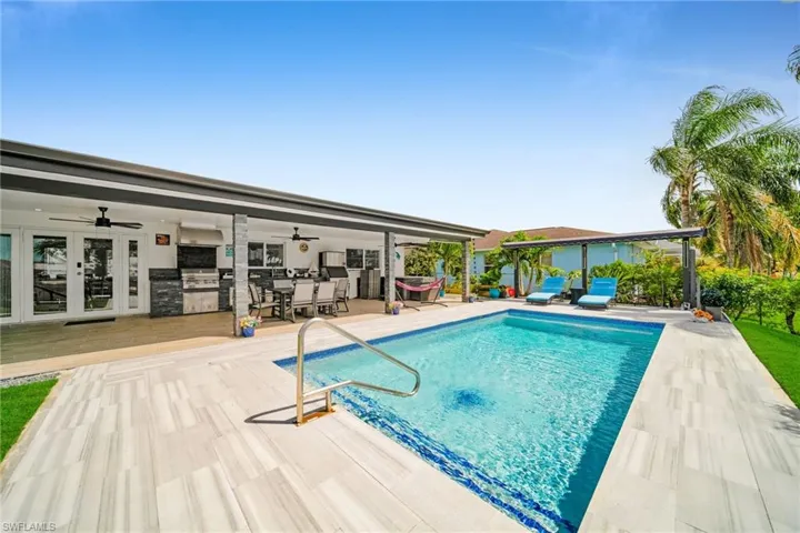 Outdoor pool with outdoor dining space, a patio, french doors, and a ceiling fan