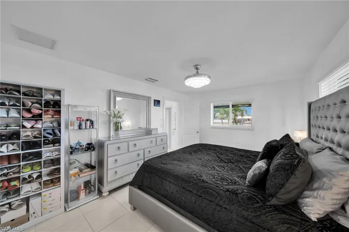 Bedroom featuring light tile patterned floors and visible vents