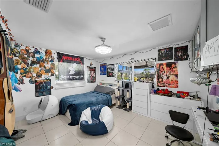 Bedroom featuring light tile patterned floors and visible vents