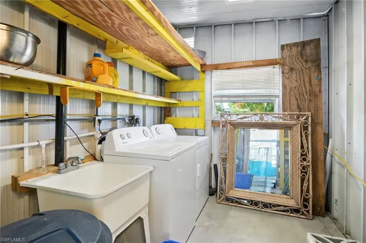 Laundry room with separate washer and dryer and huge storage area