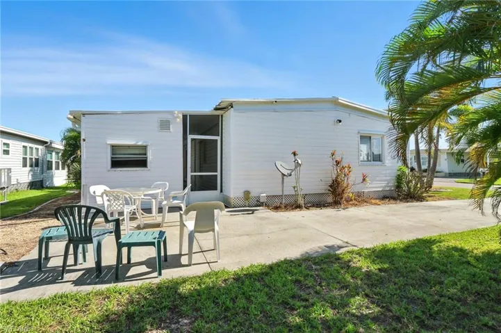 Rear view of house featuring a patio area and a lawn