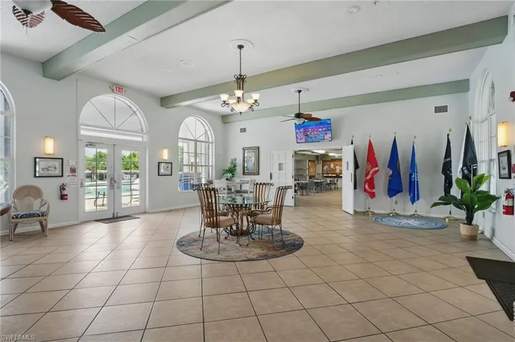 Dining room featuring ceiling fan, beam ceiling, light tile patterned floors, and french doors