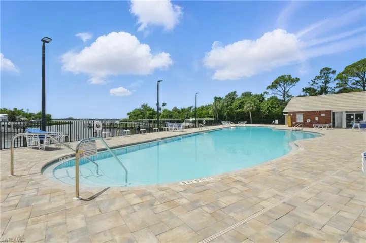 Community pool with a patio