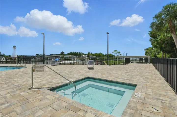 Community pool featuring a patio area and a hot tub