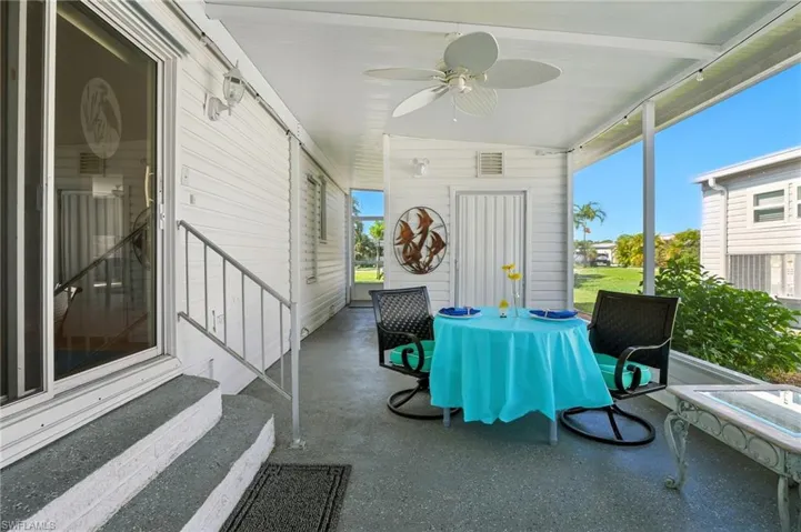 Sunroom with lofted ceiling, ceiling fan, and entry steps