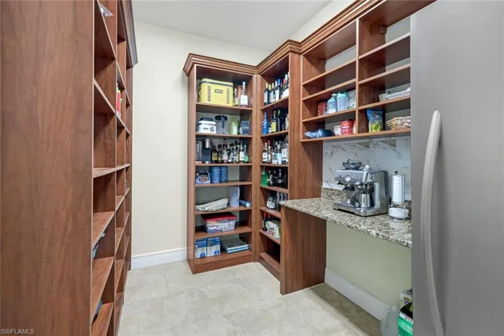 Walk in pantry with freezer and coffee bar.