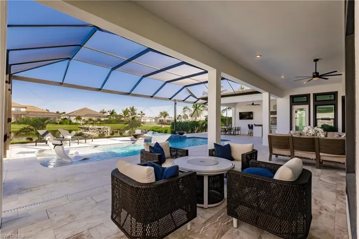 View of patio with outdoor lounge area, ceiling fan, and a lanai